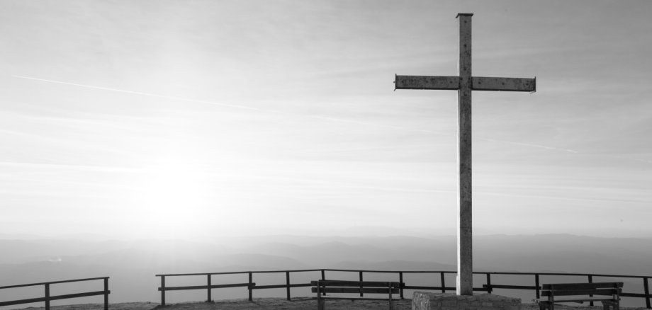 Cross on top of Mt. Serrasanta (Umbria, Italy), with sun low on the horizon